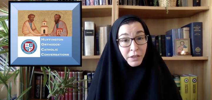 Sr. Vassa in front of bookshelves